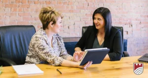 Advisor meets with a client holding a tablet