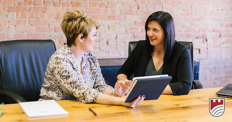 Advisor meets with a client holding a tablet