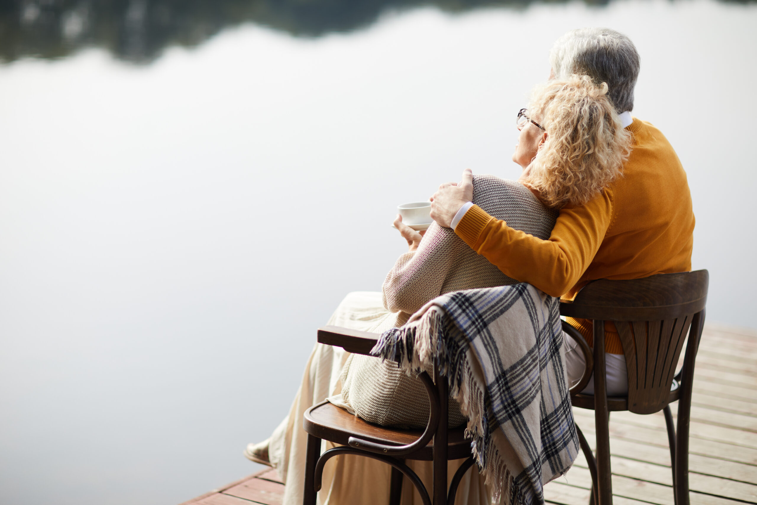 Dreamy senior couple relaxing on pier
