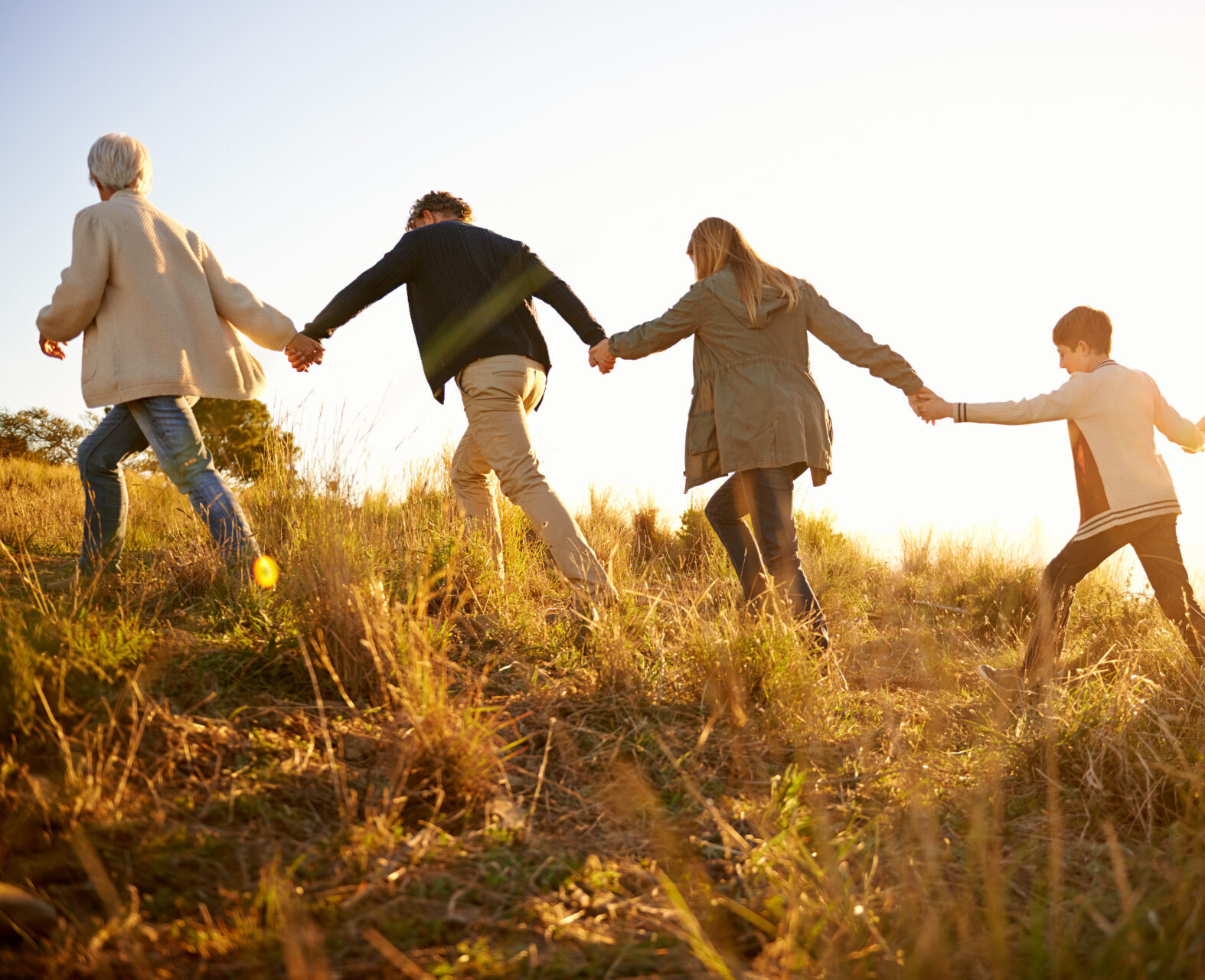 Safe in each others hands. Shot of a happy family holding hands on a morning walk together